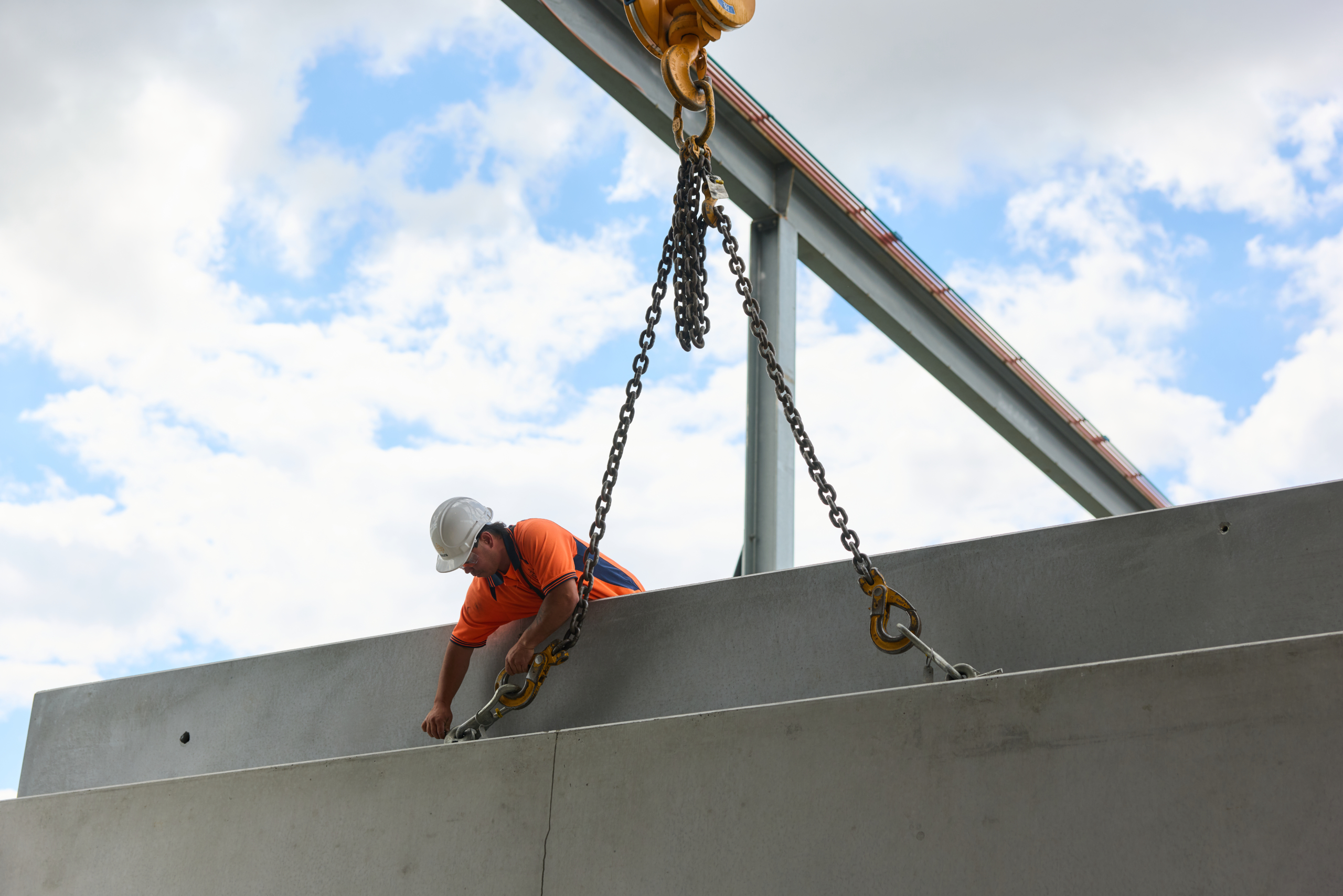 man in construction uniform handling concrete slab